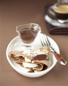 Crepes de chocolate con salsa de chocolate. Receta disponible.
