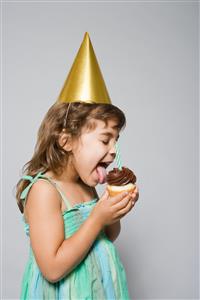 Girl licking a cupcake