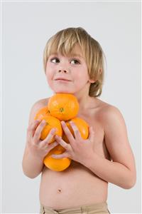 Boy holding oranges