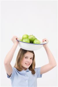 Girl with bowl of apples