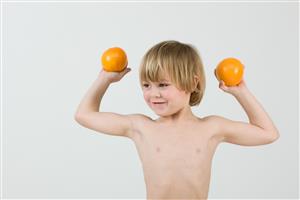 Boy holding oranges