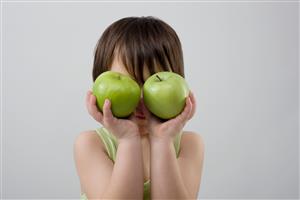 Child holding two apples