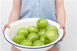 Girl with bowl of apples