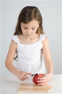 Girl peeling apple