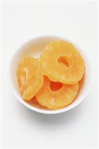 Three pineapple rings in a bowl