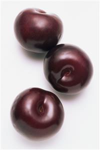 Three black amber plums