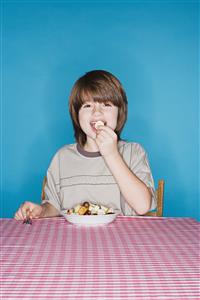 Boy eating fruit salad