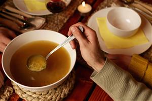 Young man serving soup